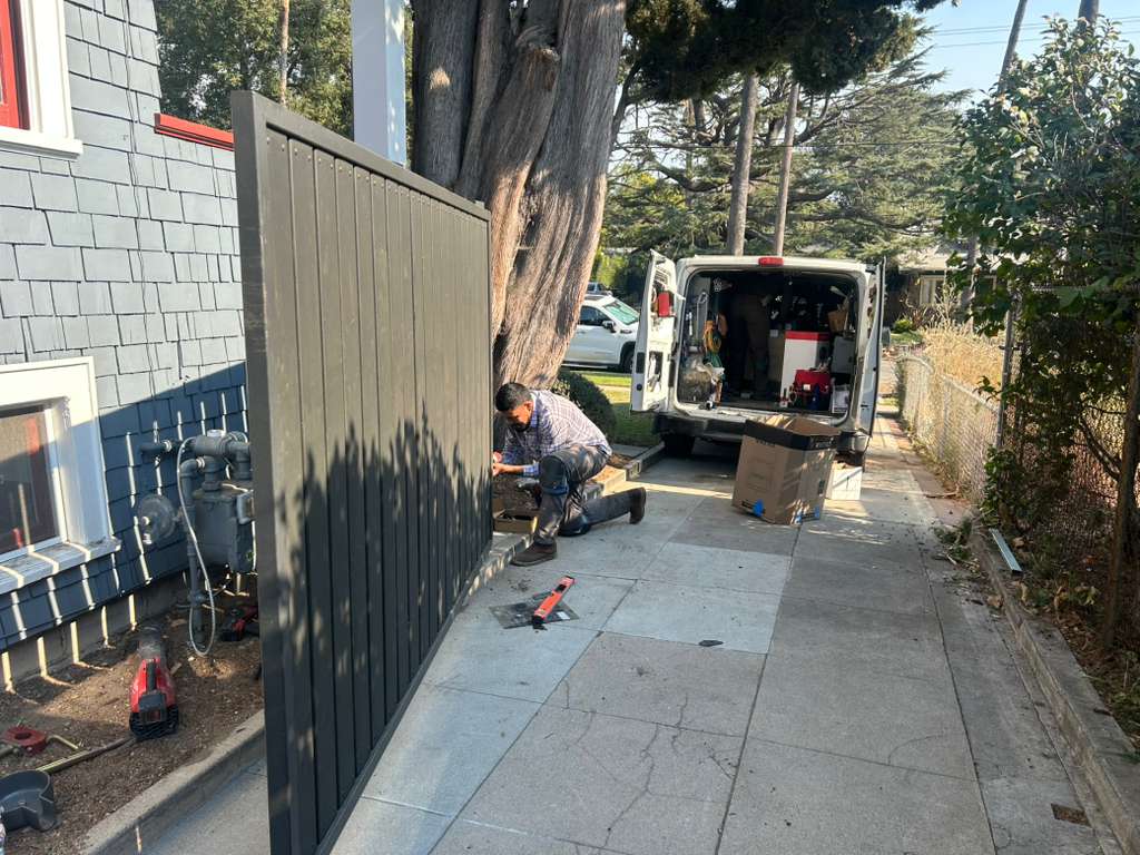 Technician repairing a wooden fence panel in Pico-Robertson, CA