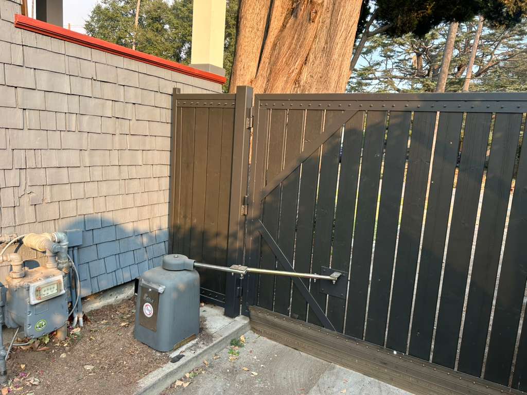 Automatic gate opener installation next to building and gas meter. in West Hollywood, CA