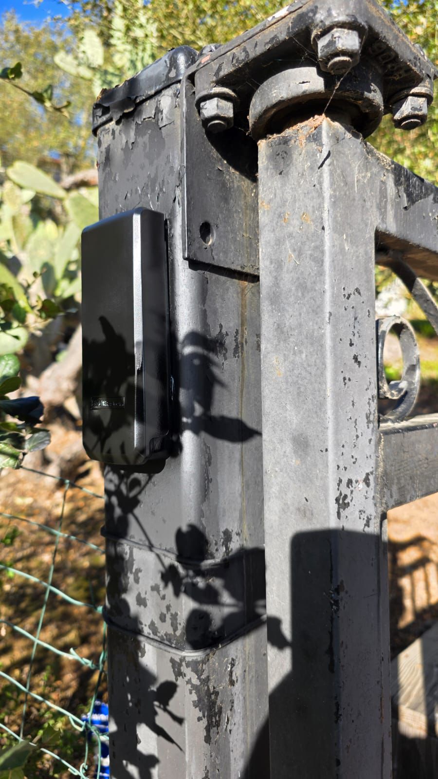 Gate access control unit on metal post with peeling paint in Hollywood, CA
