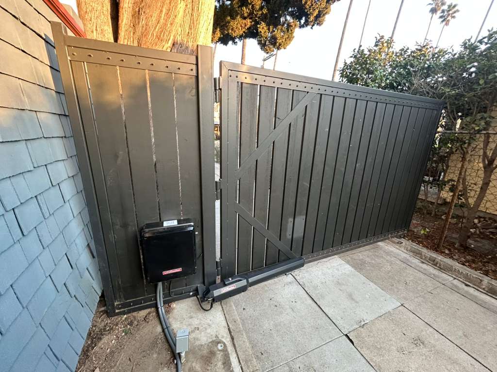 Automatic gate installation next to blue sided house in Beverly Hills, CA